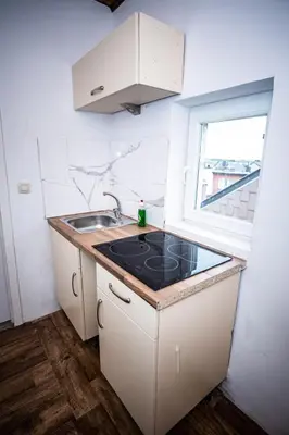 a small kitchen with a sink and a window at Superbe chambre sur liège in Liège