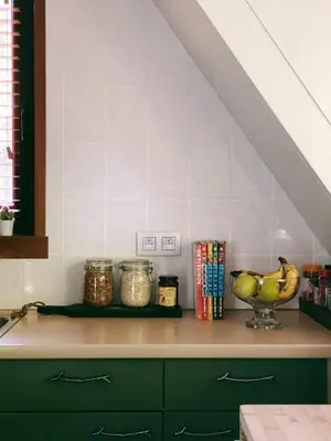 a kitchen with a counter with a bowl of fruit at Mimi's natuurhuisje in Lanaken