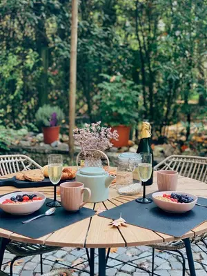 a wooden table with food and glasses of wine at Mimi's natuurhuisje in Lanaken