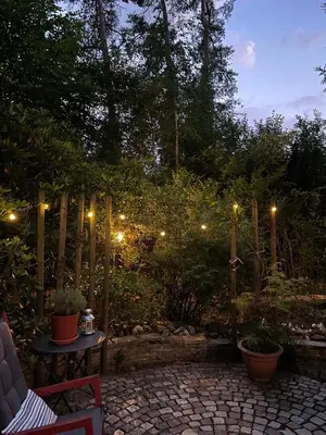 a garden at night with lights on a patio at Mimi's natuurhuisje in Lanaken