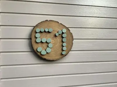 a wooden plate with pills on a wall at Isidaura in Zutendaal