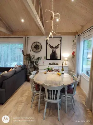 a dining room with a table and a couch at Isidaura in Zutendaal