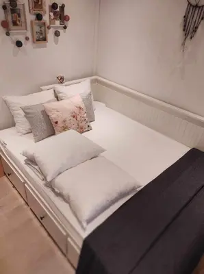 a large white bed with pillows on it at Isidaura in Zutendaal