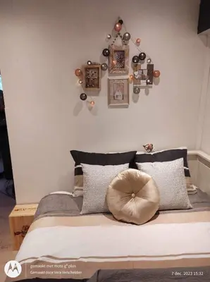 a bedroom with a large bed with some decorations on the wall at Isidaura in Zutendaal