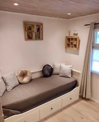 a bed with pillows on it in a room at Isidaura in Zutendaal