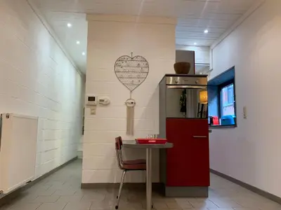 a kitchen with a table and a heart on the wall at Le Pavillon de Flore by Maison Brasseurs d'Etoiles - Appartement 2 personnes in Liège