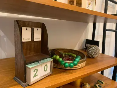 a wooden clock on a shelf with a basket of balls at Le Pavillon de Flore by Maison Brasseurs d'Etoiles - Appartement 2 personnes in Liège