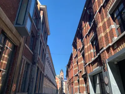 an alley between brick buildings on a city street at Le Pavillon de Flore by Maison Brasseurs d'Etoiles - Appartement 2 personnes in Liège