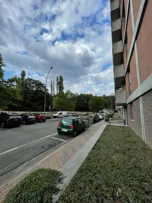 a green car parked on a street next to a building at Alexis's loft in Liège