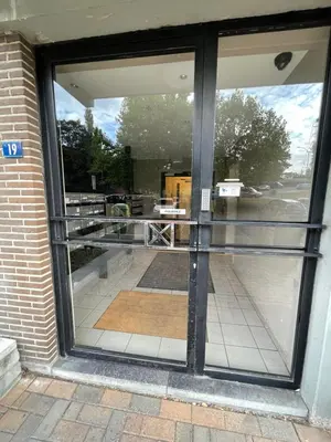 a large glass door of a building with a patio at Alexis's loft in Liège