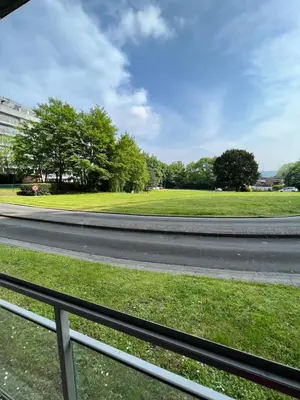 a view of a road with a grass field at Alexis's loft in Liège