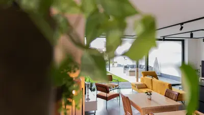 a living room with couches and a table and chairs at B&B Koor91 in Hasselt
