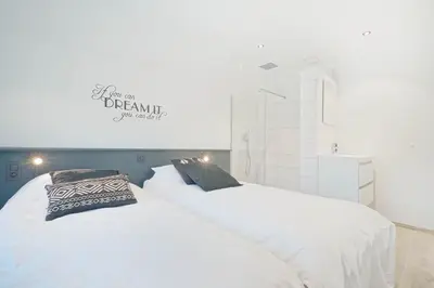 two white beds sitting next to each other in a room at Gîtes Chez Oncle Nicolas in Soumagne
