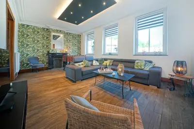 a living room with a couch and a table at Gîtes Chez Oncle Nicolas in Soumagne