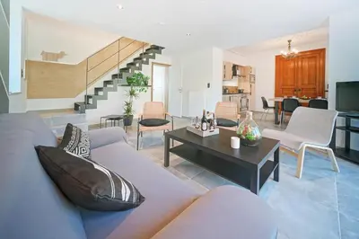 a living room with a couch and a table at Gîtes Chez Oncle Nicolas in Soumagne