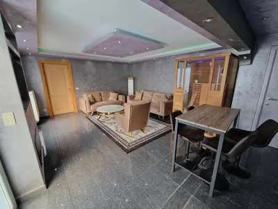 a living room with a table and chairs and a couch at Tendresse - Espace Détente Ensival in Verviers