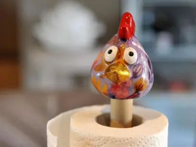 a toy chicken is sitting on top of a holder at Vlaanderen Cozy Cottage in Eisden