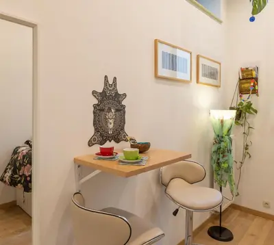 a small table and two chairs in a room at La Chambre Suspendue by Maison Brasseurs d'Etoiles - Appartement 2 personnes in Liège