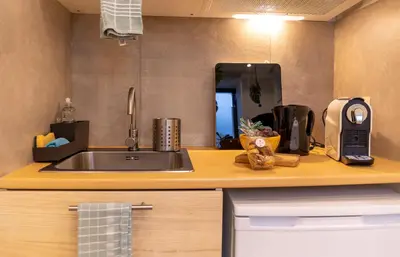 a kitchen counter with a sink and a mirror at La Chambre Suspendue by Maison Brasseurs d'Etoiles - Appartement 2 personnes in Liège