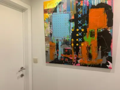 a painting hanging on a wall next to a door at La Chambre Suspendue by Maison Brasseurs d'Etoiles - Appartement 2 personnes in Liège