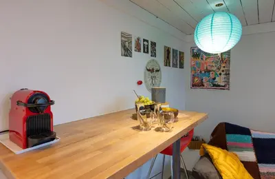 a room with a wooden table with glasses on it at Le Studio Compostelle by Maison Brasseurs d'Etoiles - Appartement 2 personnes in Liège