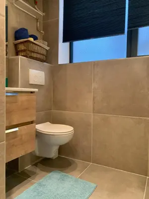a bathroom with a toilet and a window at Le Studio Compostelle by Maison Brasseurs d'Etoiles - Appartement 2 personnes in Liège