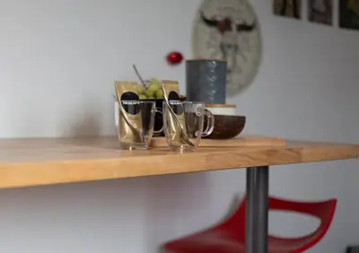 a wooden shelf with three pairs of shoes on it at Le Studio Compostelle by Maison Brasseurs d'Etoiles - Appartement 2 personnes in Liège