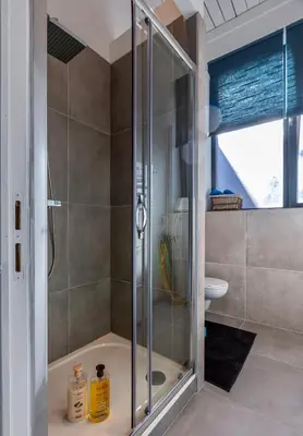 a shower with a glass door in a bathroom at Le Studio Compostelle by Maison Brasseurs d'Etoiles - Appartement 2 personnes in Liège