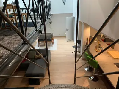 a view of a living room from the stairs at Le Loft Nautilus by Maison Brasseurs d'Etoiles in Liège
