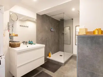 a bathroom with a white sink and a shower at Le Loft Nautilus by Maison Brasseurs d'Etoiles in Liège