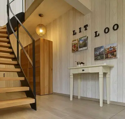 a room with a staircase and a table and a stair case at lit-loo in Hasselt