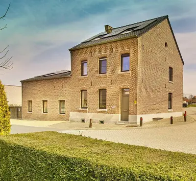 a large brick building with a roof at lit-loo in Hasselt