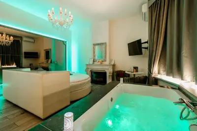a bathroom with a large tub with a fireplace at Ô Secret in Liège