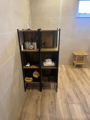 a wooden shelf in a bathroom with a shower at JustB in Riemst