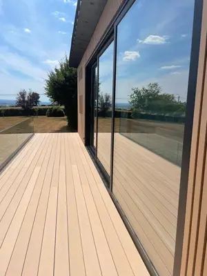 a balcony with glass doors and a view of a field at Tiny house moderne in Thimister