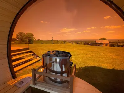 a trash can sitting outside of a barn at Tiny house moderne in Thimister