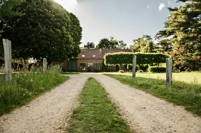 a dirt road leading to a farm house at Villa Vigor in Peer