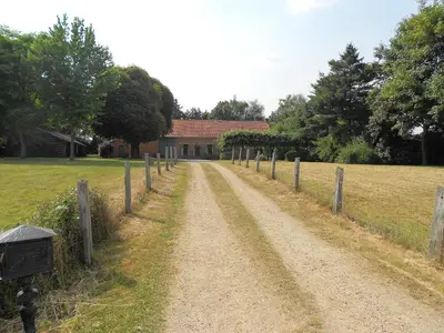 a dirt road in front of a house with a fence at Villa Vigor in Peer