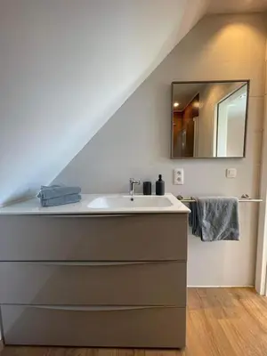 a bathroom with a sink and a mirror at Au cœur de l'Ardenne Bleue - Studio avec piscine in Baelen