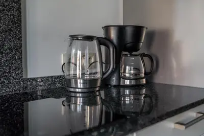 a kitchen counter with a blender and a coffee maker at De Hoog Velden 11 in Pelt