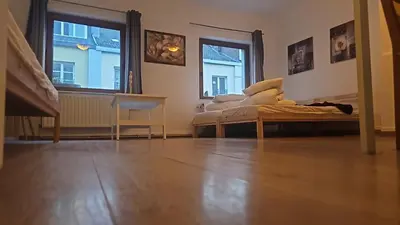 a room with a bed and two windows at Studio régence in Liège