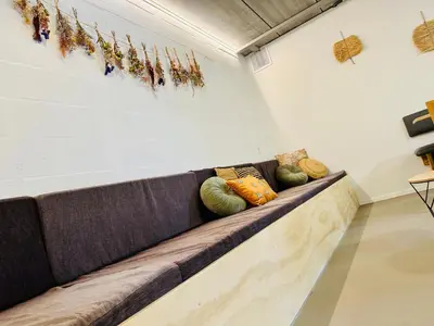 a couch in a room with pillows on it at La Bel échappée in Aubel
