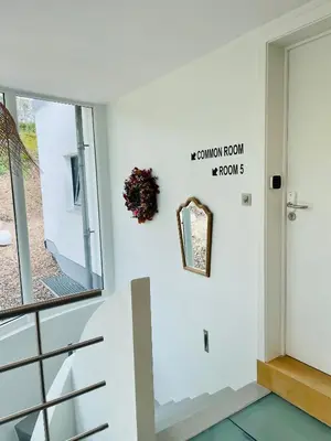 a stairway room with white walls and a window at La Bel échappée in Aubel