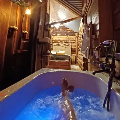 a person in a bath tub in a bathroom at La Cabane du Coing in Visé