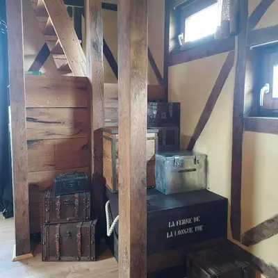 a room with suitcases stacked on top of each other at La Cabane du Coing in Visé