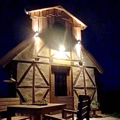 a building with a table and a light on it at La Cabane du Coing in Visé
