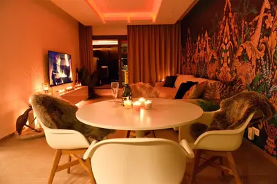 a living room with a table and chairs and a couch at SuiteDreams-Jungle Suite - Liège in Liège