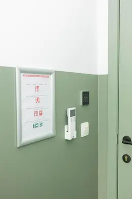 a sign on the wall of a hospital emergency room at City Housing Genk in Genk