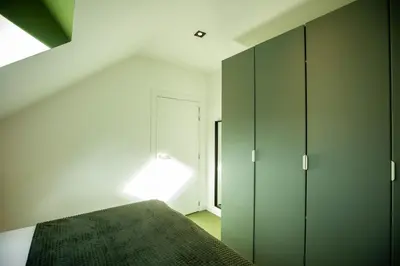 a bedroom with a bed and a window at City Housing Genk in Genk
