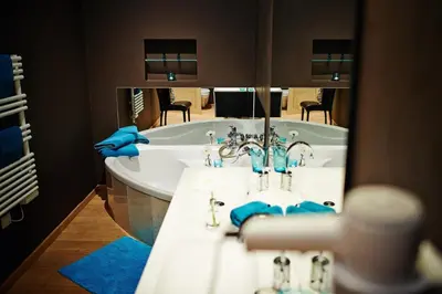 a bathroom with two sinks and a large mirror at B&B Au Clair Obscur in Verviers